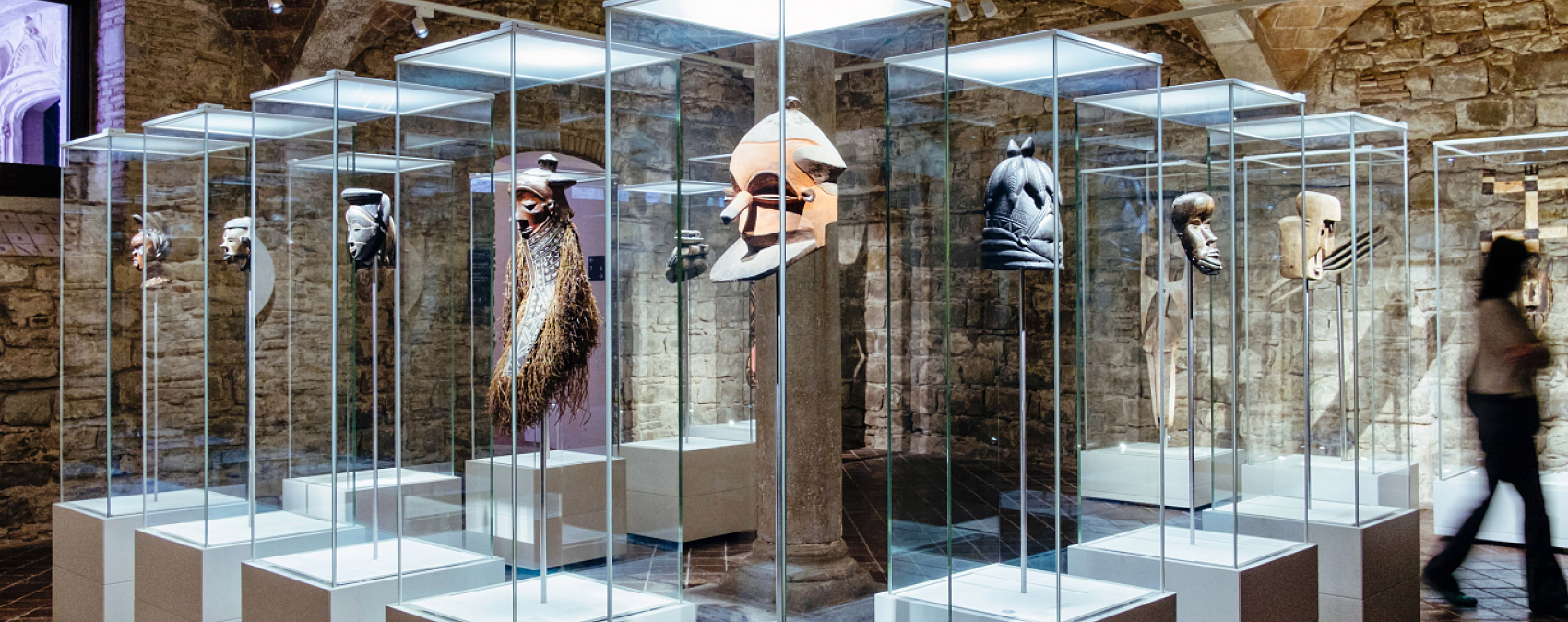 African masks in illuminated display cases with ERCO Optec spotlights at Museu de Cultures del Món, Barcelona.